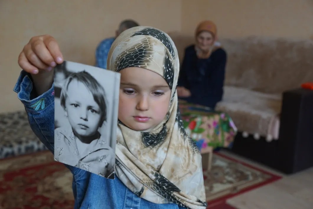Шестилетняя Асия Сулейманова с фотографией отца. Из архива Антона Наумлюка