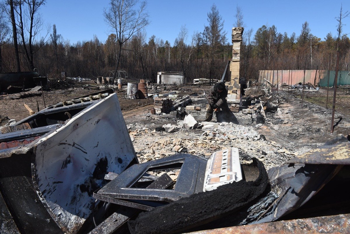 Житель Смоленки разбирает завалы на пепелище своего дома