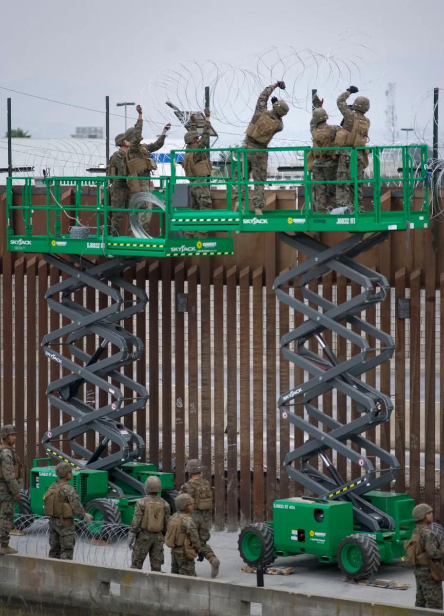 Военные оснащают стену колючей проволокой. Фото: ЕРА