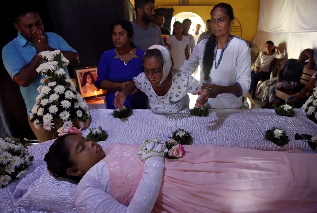 Пострадавшая от взрывов женщина у тела погибшей внучки. Коломбо, Шри-Ланка. Фото: Reuters
