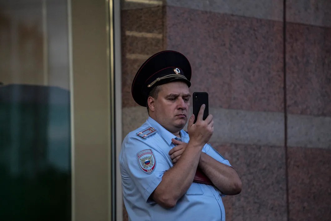 Сотрудник полиции ведет съемку во время митинга. Фото: Влад Докшин / «Новая газета»
