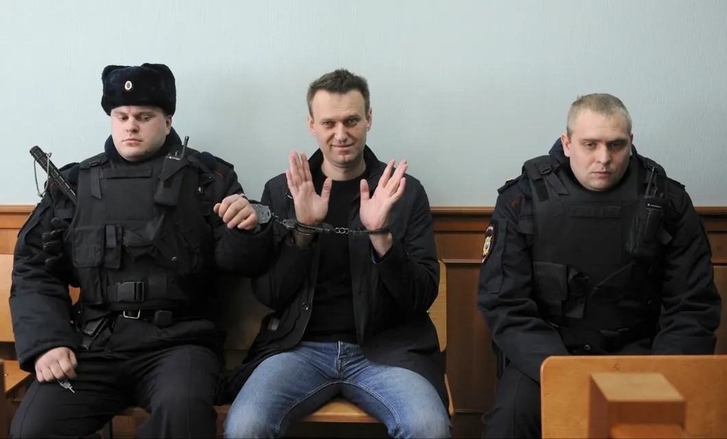 Алексей Навальный и конвой в зале суда. На Навальном две пары наручников. Фото: ТАСС