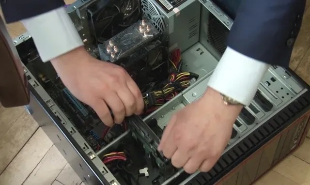 Сотрудник МВД изымает жесткий диск компьютера во время обыска. Фото: РИА Новости