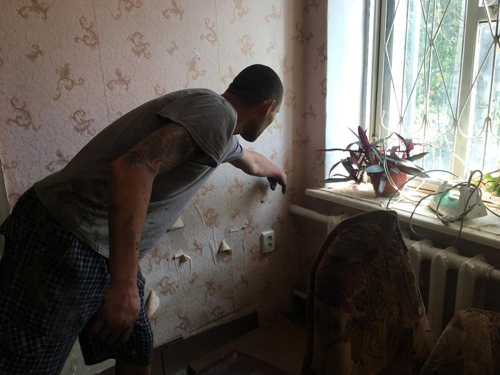 Евгений Праворчук показывает уровень воды, который был в доме утром 17 июня. Фото: Анастасия Смирнова