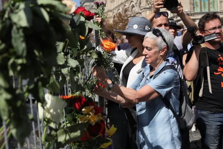 Участники акции крепят цветы к забору у Лобного места. Красная площадь частично огорожена из-за прошедшего вчера фестиваля Спасская башня, Влад Докшин/ «Новая газета»