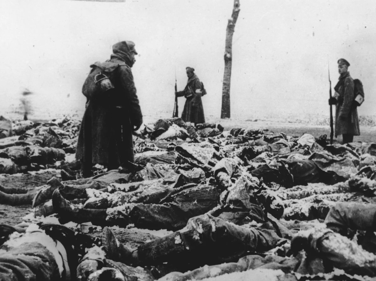 Солдаты на поле битвы среди груды трупов во время Первой мировой войны. Фото: Репродукция ТАСС