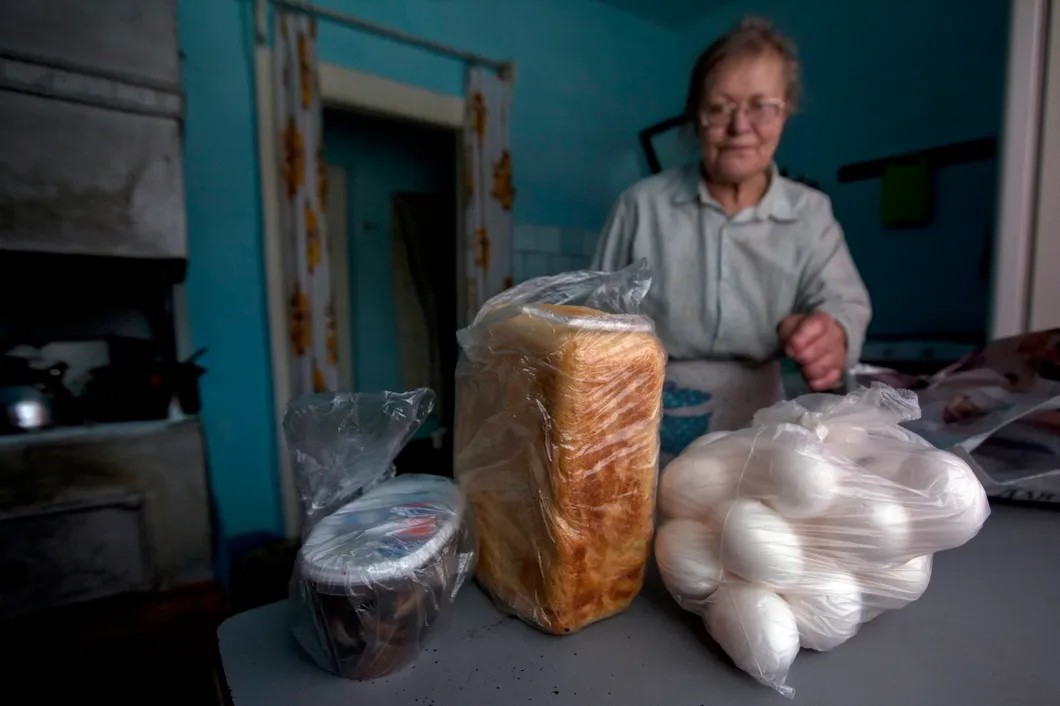 Пенсионерка получила продукты от сотрудника социальной службы. Фото: РИА Новости