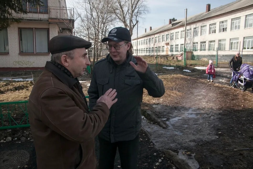 Александр спорит о своем творчестве с местным жителем. Фото: Влад Докшин / «Новая газета»