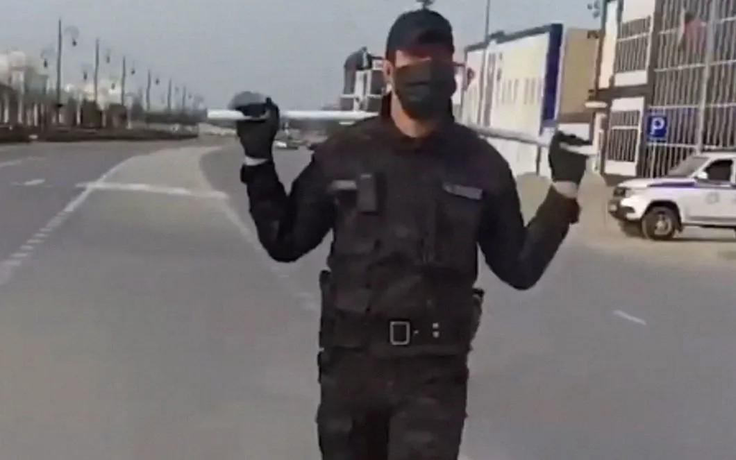 A Chechen policeman carrying a polypropylene stick. Screenshot