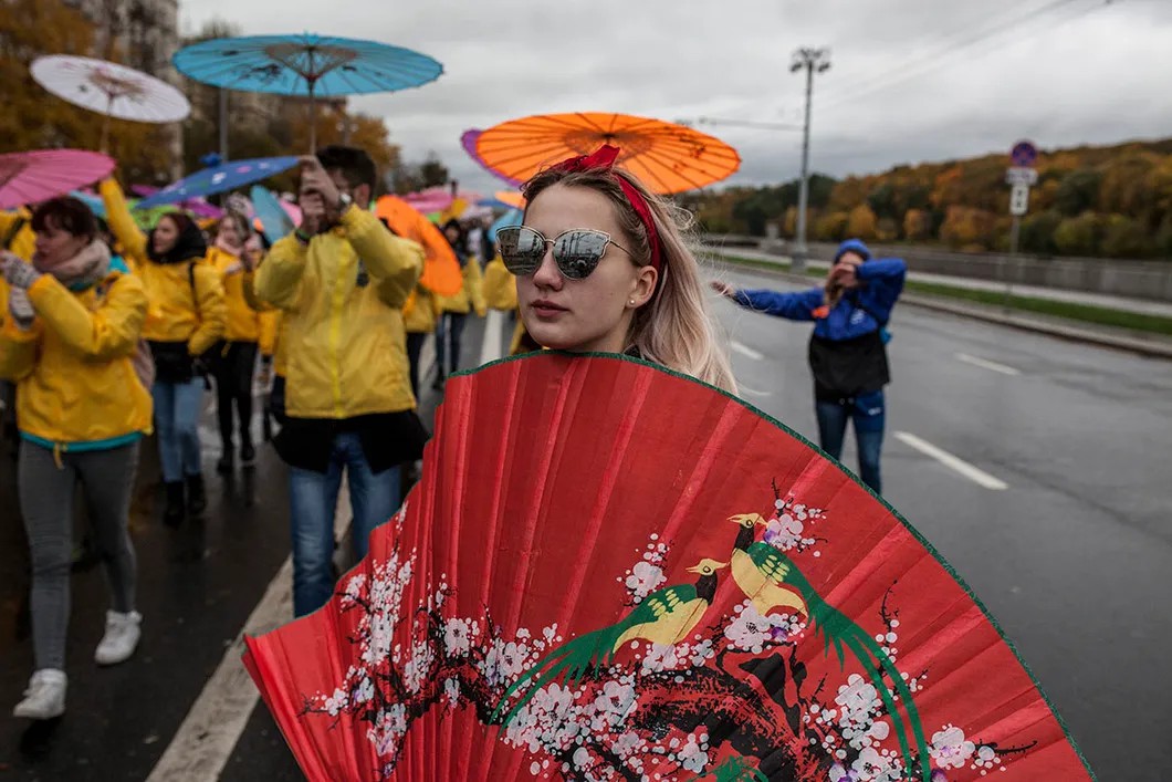 Российская студентка в китайской колонне шествия. Фото: Влад Докшин / «Новая газета»